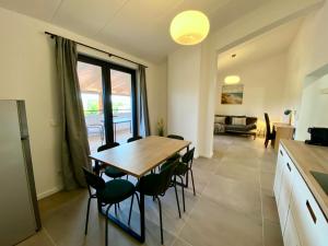 a kitchen and dining room with a table and chairs at Spacious, Newly Renovated, Pula Rooftop Apartment with Marina Views in Pula