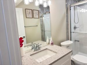 a bathroom with a sink and a toilet at Annas Suites Rental in Bélanger +37 photos