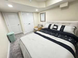 a bedroom with a large bed with black and white pillows at Annas Suites Rental in Bélanger