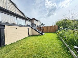 an empty yard next to a house with a fence at Annas Suites Rental in Bélanger