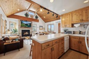 a kitchen and living room with a fireplace at Cozy Hillside Cottage Overlooking Main Street in Park City