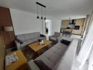a living room with a couch and a table at Jakiland house Plitvice Lakes in Korenica