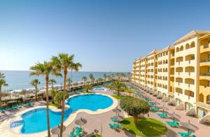 an aerial view of a resort with a swimming pool and the ocean at Hotel IPV Palace & Spa - Adults Recommended in Fuengirola