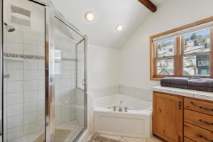 a bathroom with a shower and a toilet and a sink at Cozy Hillside Cottage Overlooking Main Street in Park City +46 photos