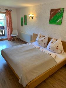 a bedroom with a large bed with white sheets and pillows at Aussermooserhof in Alpbach
