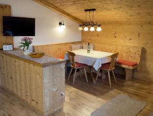 a dining room with a white table and chairs at Aussermooserhof in Alpbach