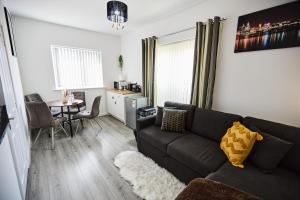 a living room with a couch and a table at Ampee Guest Suite-Free Parking in Liverpool