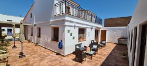 a house with a patio with chairs on it at Casa l'Arrossal - Adults Only in El Poblenou del Delta