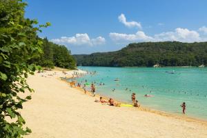 a group of people in the water at a beach at Chambre le Faucon in Cernon