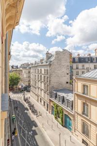 a view of a street in a city with buildings at Hotel Riviera OPERA Cadet in Paris