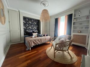 a living room with a chair and a couch at gite Chezelle in Saint-Georges-sur-Cher