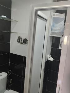 a bathroom with a shower with a toilet and a mirror at Dar Yasmine in Ifrane