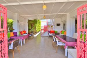 a restaurant with tables and chairs and colorful tables at Kiraz Butik Hotel in Alaçatı