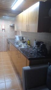 a kitchen with a sink and a counter top at Casa do avô Almeida in Lajes das Flores