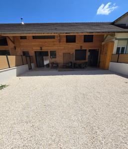 a large building with a large patio in front of it at gites des ammonites in Montalieu-Vercieu