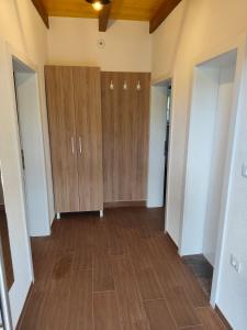 an empty room with wooden cabinets and a wood floor at villa Tema 2 in Ohrid