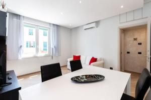 Un comedor blanco con una mesa y sillas blancas. en Luna House, en La Spezia 10 fotos más