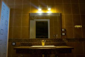 a bathroom with a sink and a mirror at فيلا كمبوند رويال سيتي in Sheikh Zayed +13 photos