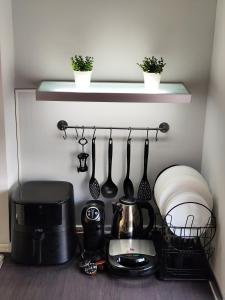 a kitchen shelf with utensils and a coffee maker at Balcon Six2point in Xanthi +10 photos