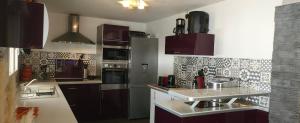 a kitchen with brown cabinets and a counter top at Villa avec piscine privée en Normandie in Saint-Clair-dʼArcey