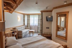 Postel nebo postele na pokoji v ubytování Hotel Garnì Paradisi - Wellness & Spa + 41 fotografií