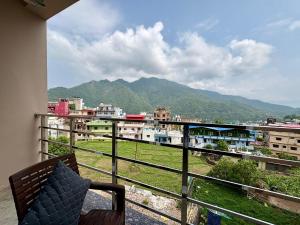 a balcony with a view of a city and mountains at Hotel Uday Palace in Rishīkesh