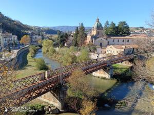 a bridge over a river with a town in the background at Dimora al Centro in Cosenza