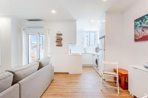 a living room with a couch and a kitchen at Bright 2BDR Flat in Armação de Pêra by LovelyStay in Armação de Pêra +23 photos