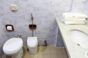 a bathroom with a white toilet and a sink at Days inn by Wyndham Uberlândia in Uberlândia