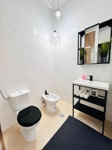 a bathroom with a toilet and a sink at Luxury rooms in the centre of Lisbon, Alfama in Lisbon