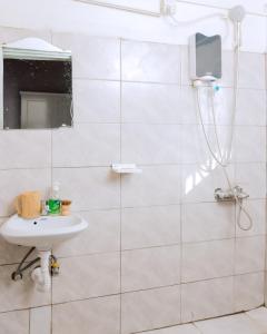 a white bathroom with a sink and a mirror at Hi-Pima Boutique Hotel in Kigali +21 photos