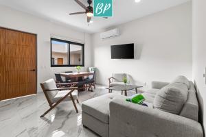 a living room with a couch and a table at Stanza Bucerias Condos - Pool Parking & Near Beach in Bucerías