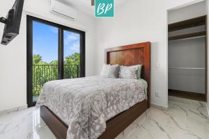 a bedroom with a bed and a large window at Stanza Bucerias Condos - Pool Parking & Near Beach in Bucerías +21 photos