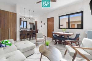 a living room with a couch and a table at Stanza Bucerias Condos - Pool Parking & Near Beach in Bucerías
