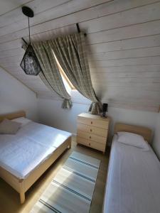 a bedroom with two beds and a window at Mamma Mia Park in Łukęcin +47 photos