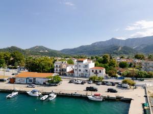 a marina with boats in the water and buildings at Sonia's Maison in Limenas