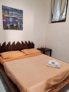 a bedroom with a bed with two towels on it at Casa al Mare in Bisceglie