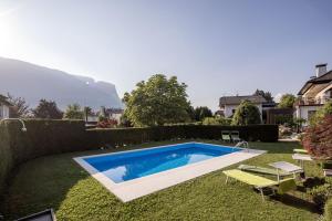 a swimming pool in the yard of a house at Villa Sawian in Appiano sulla Strada del Vino