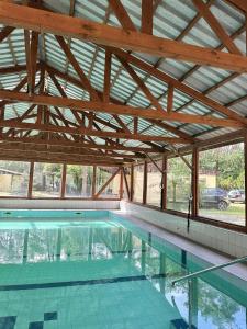 a large swimming pool with a wooden roof at U Karola in Karpicko