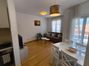 a living room with a table and a couch at Sea view Chiron in Budva