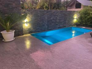 a swimming pool in a backyard with lights at Maison Marie Jeanne - Unit 1 in Baie Sainte Anne