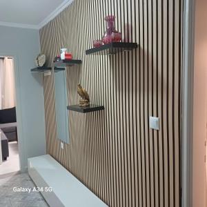 a room with three shelves on a wall at Cleopatra Apartment in Himare