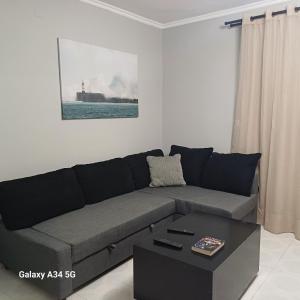 a living room with a couch and a coffee table at Cleopatra Apartment in Himare