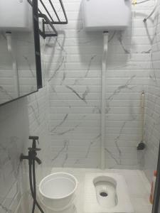a bathroom with a white toilet in a room at Yueeda Homestay in Jertih +20 photos