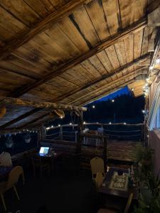 a restaurant with a wooden ceiling and tables and chairs at Cabana Dor de-Acas / Restaurant Dor de-Acas in Gura Haitii +18 photos
