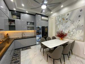 a kitchen with a table and chairs and a sink at Happy House in Cat Ba