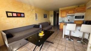 a living room with a couch and a kitchen at Les Haut Du Lac in Sainte-Croix-de-Verdon +12 photos