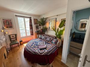 a bedroom with a bed and a dresser in it at Chambre rétro in Paris +1 photo