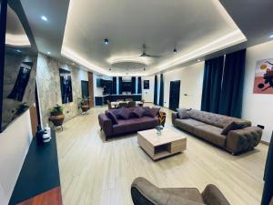 a large living room with couches and a table at Platinum Blue Island Resort in Atimpoko