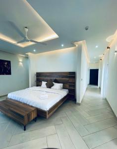 a bedroom with a large bed with a wooden headboard at Platinum Blue Island Resort in Atimpoko +126 photos